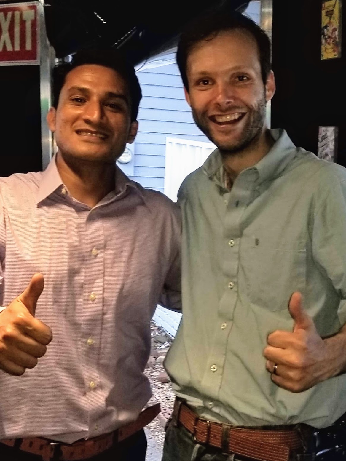 Two people giving a big happy thumbs up!